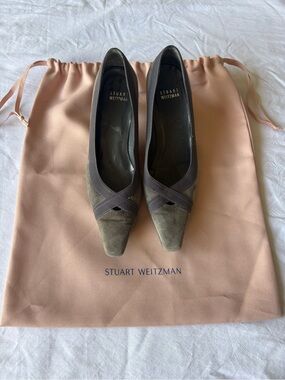 Stuart Weitzman smoky gray suede pumps with a cross-grain ribbon accent.